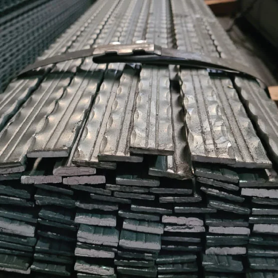 Textured flat steel bars with ribbed surfaces for improved bonding and stability